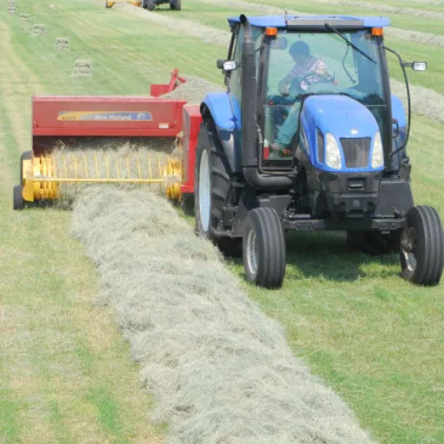 A tractor bailing hay.