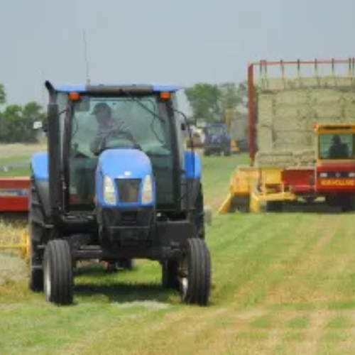 Tractor bailing hay.