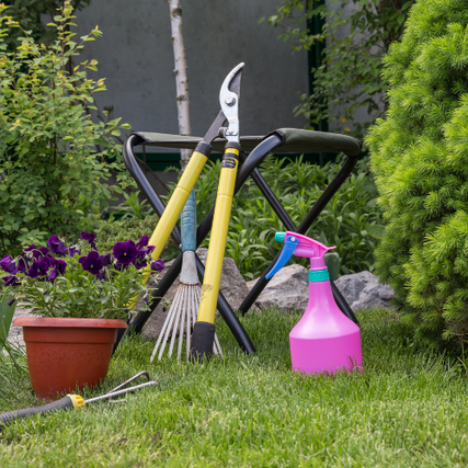 Lawn & GardenAn array of lawn and garden tools posed outside on a clear day.